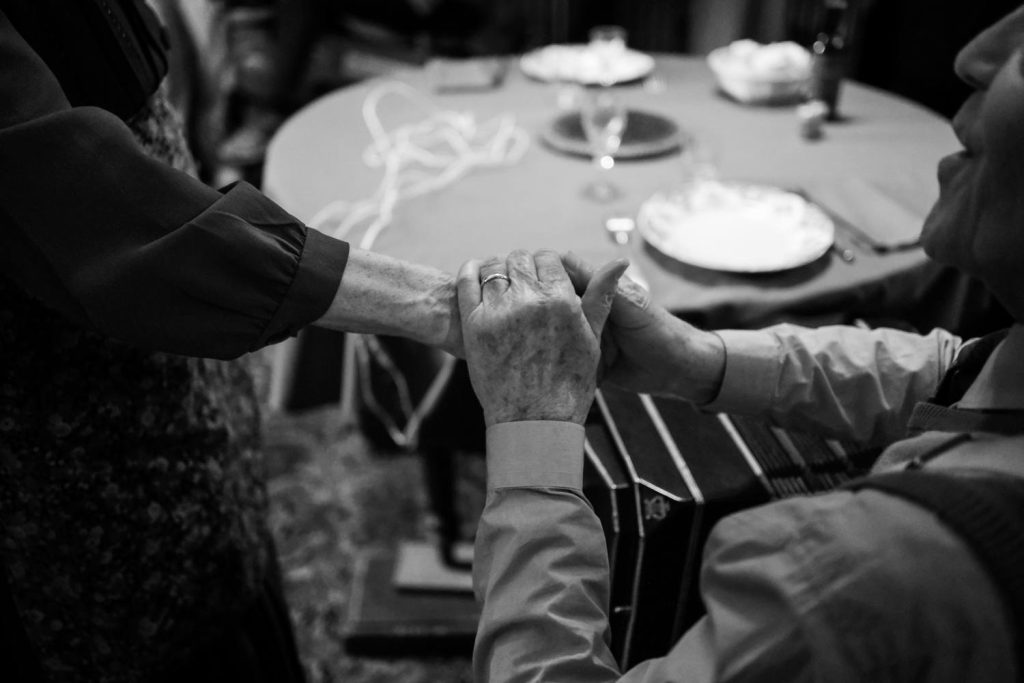 Des mains sur la table dressée, autour du bandonéon